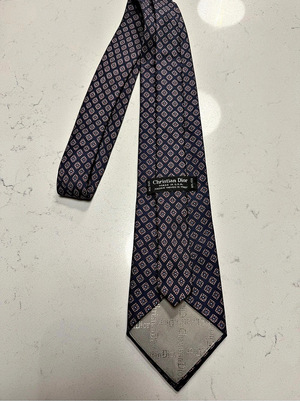 Christian Dior men’s necktie featuring a navy blue background